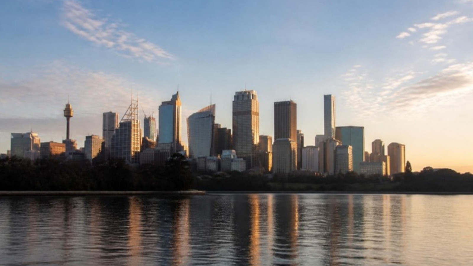 Sydney city skyline at first light, seen across the harbour