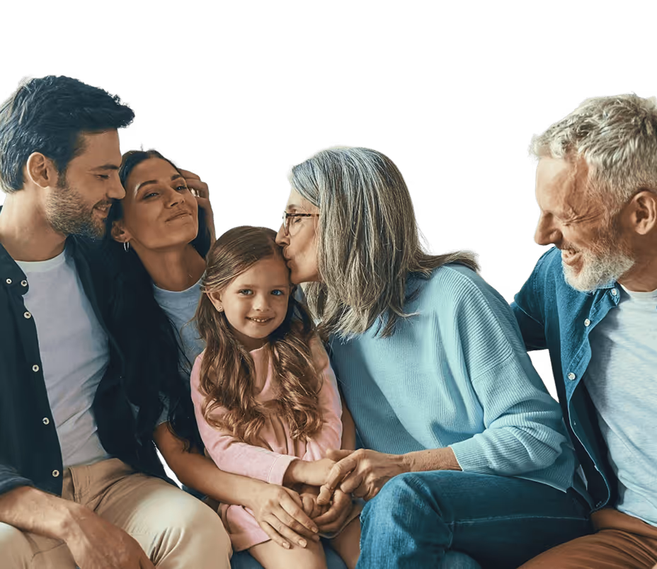 Smiling family generations together with grandmother kissing young girl on forehead.