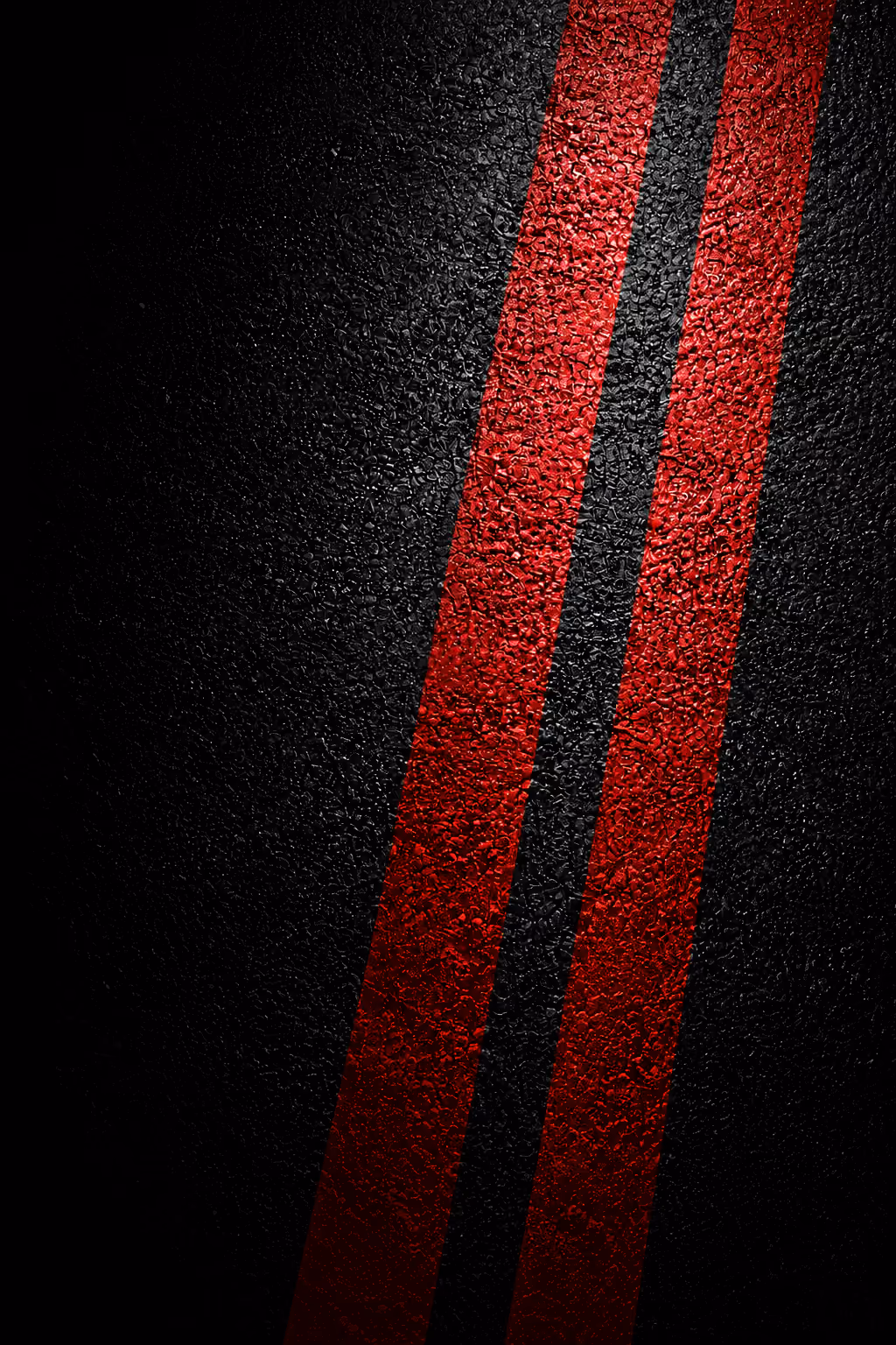 Two parallel red stripes on a textured black surface, creating a sleek and dramatic contrast.
