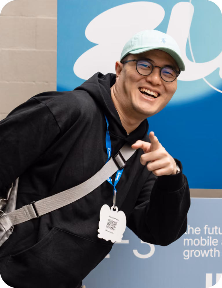 Almedia employee smiling and pointing at the camera