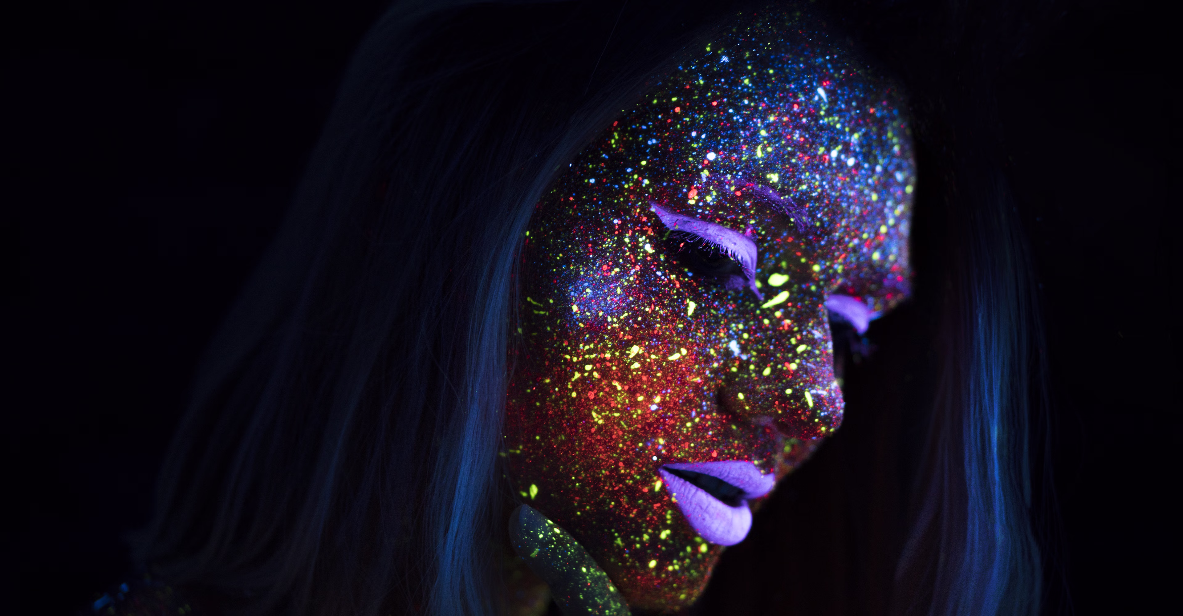 A womans face in neon light.