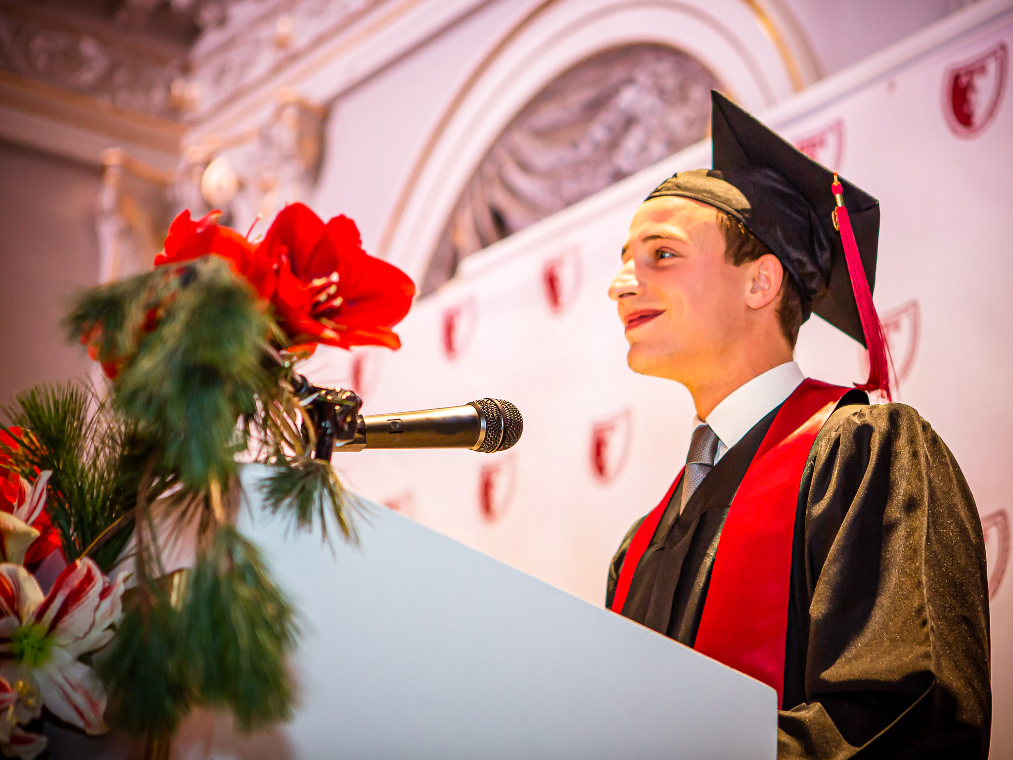 An AUS graduate speaking with the university community
