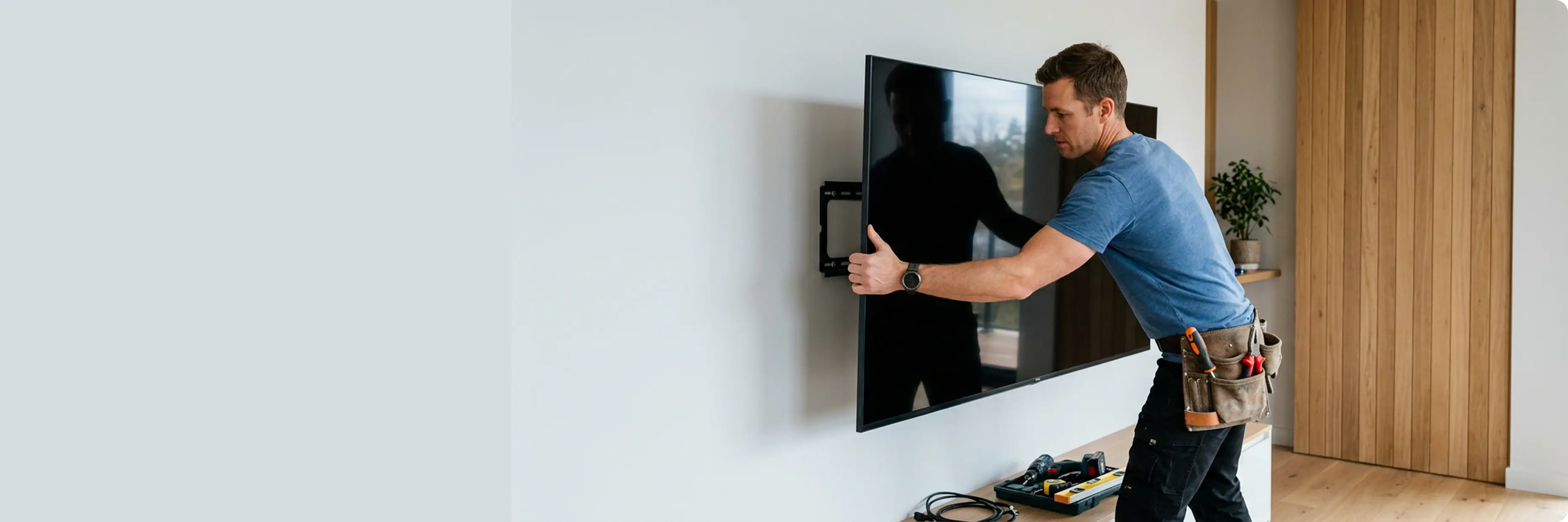 UrbanOrbits technician mounting a wall-mounted TV in a Los Angeles home