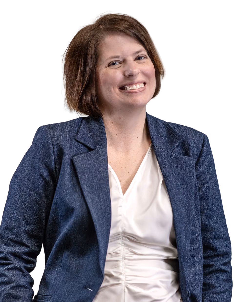 Smiling woman with short brown hair wearing a navy blazer and white ruched blouse.
