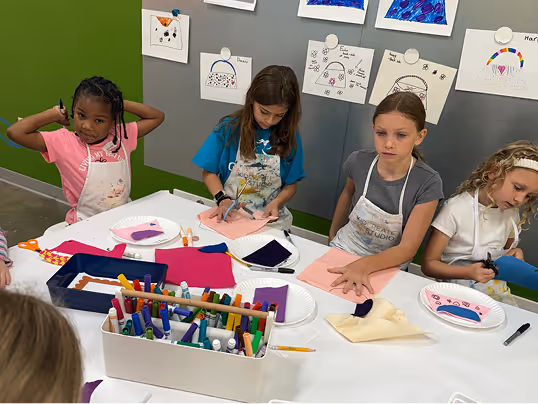 A Kidcreate kid mid-project with glittery materials