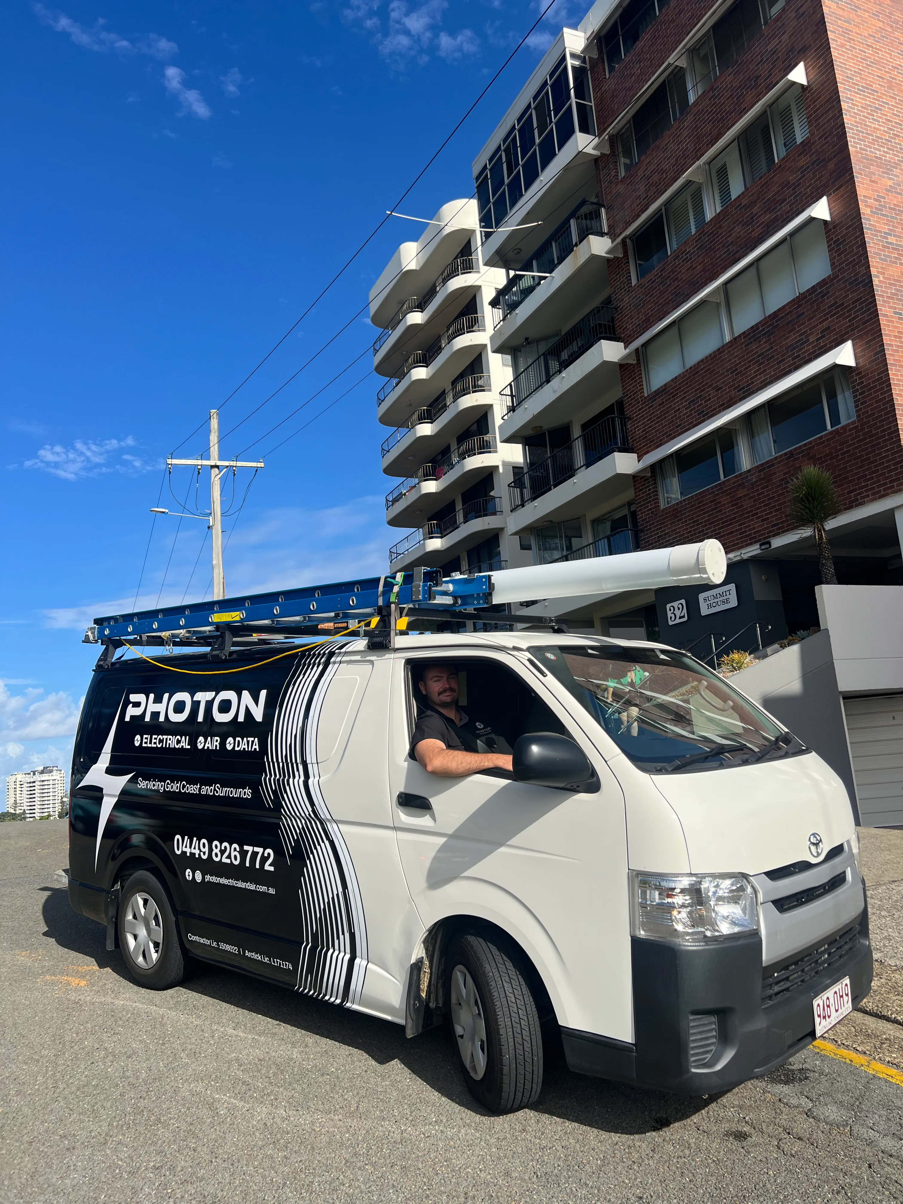 Aidan from Photon Electrical & Air, licensed Gold Coast electrician with work van