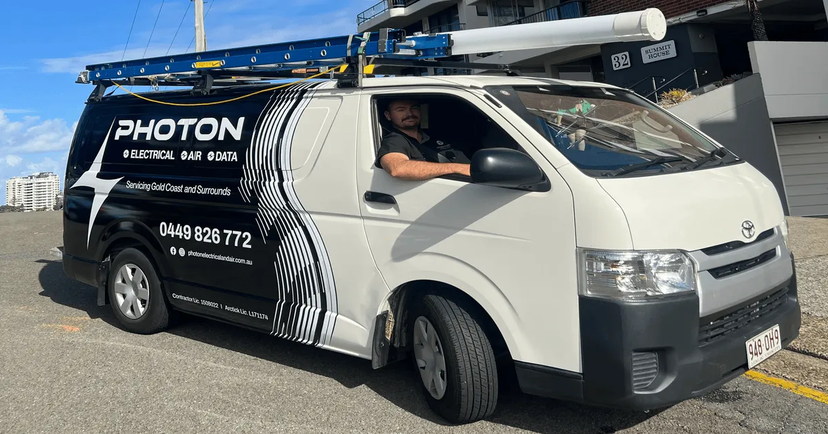 Aidan from Photon Electrical & Air, licensed Gold Coast electrician with work van