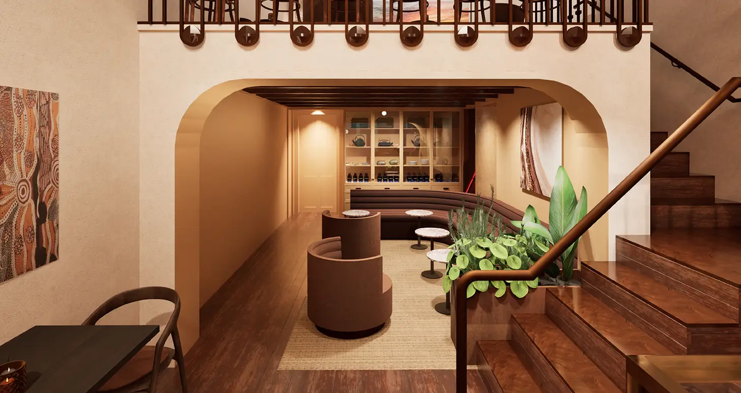 Warm, earthy-toned interior lounge at HUMM wellness hub in St Kilda, featuring an arched alcove with curved banquette seating, timber flooring, a glass retail shelf displaying teas and wellness products, Indigenous artwork, and a timber staircase.