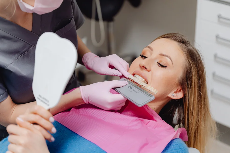 woman-checking-new-veneers-mirror-affordable-veneers-atlanta