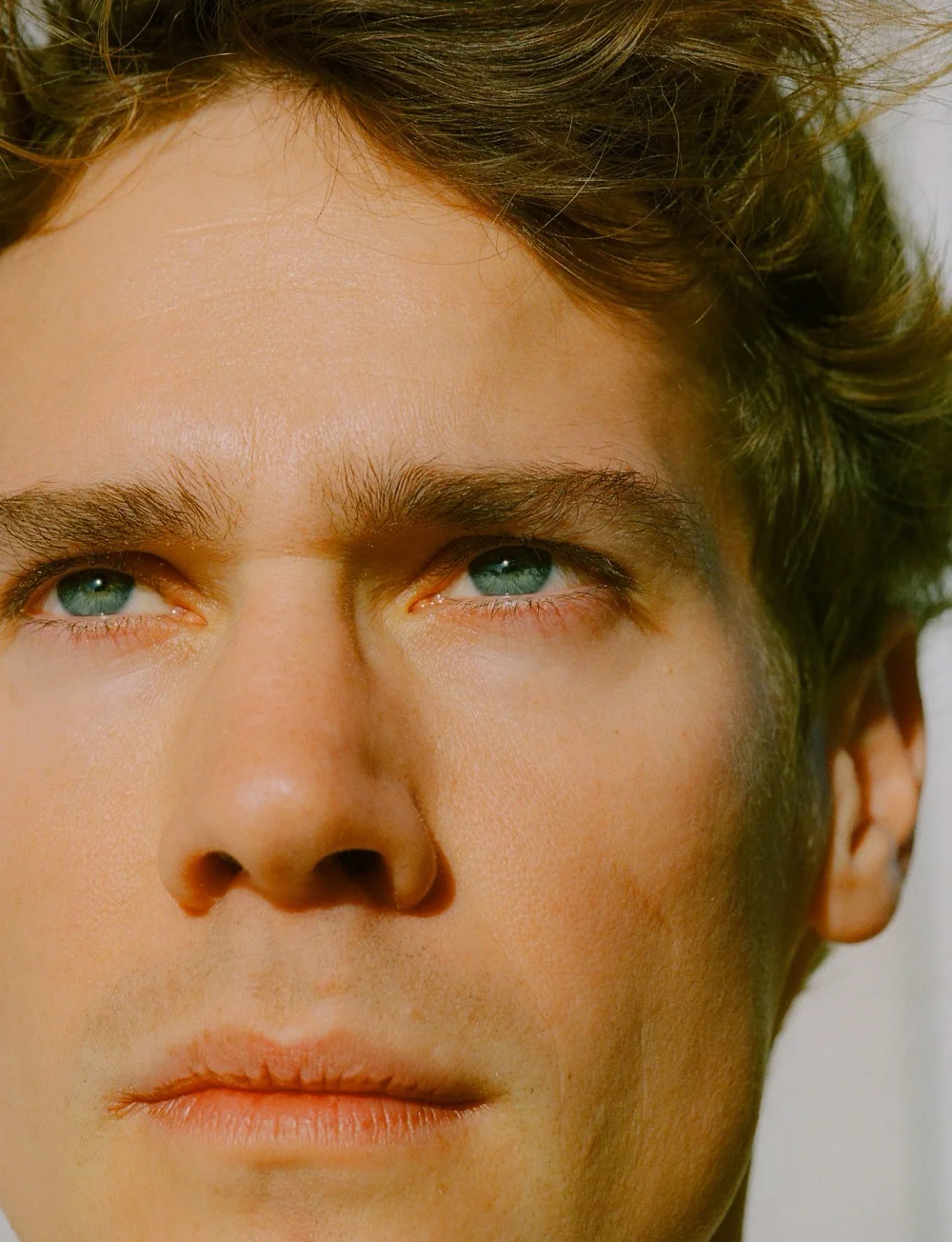 Close-up analog portrait of Patrick Pilz in warm Mallorca light.