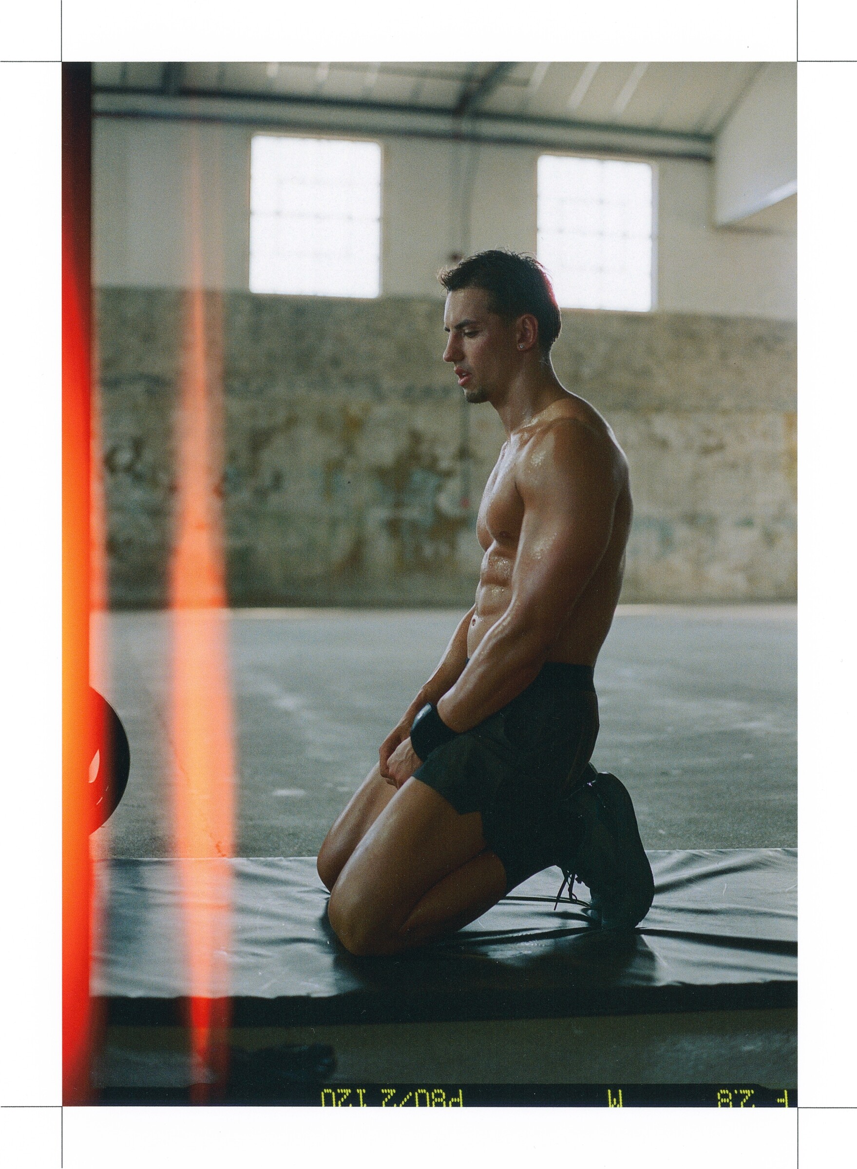 DESCENTE Athletic Originals: Athlete kneeling on a mat, framed by a warm film light leak.