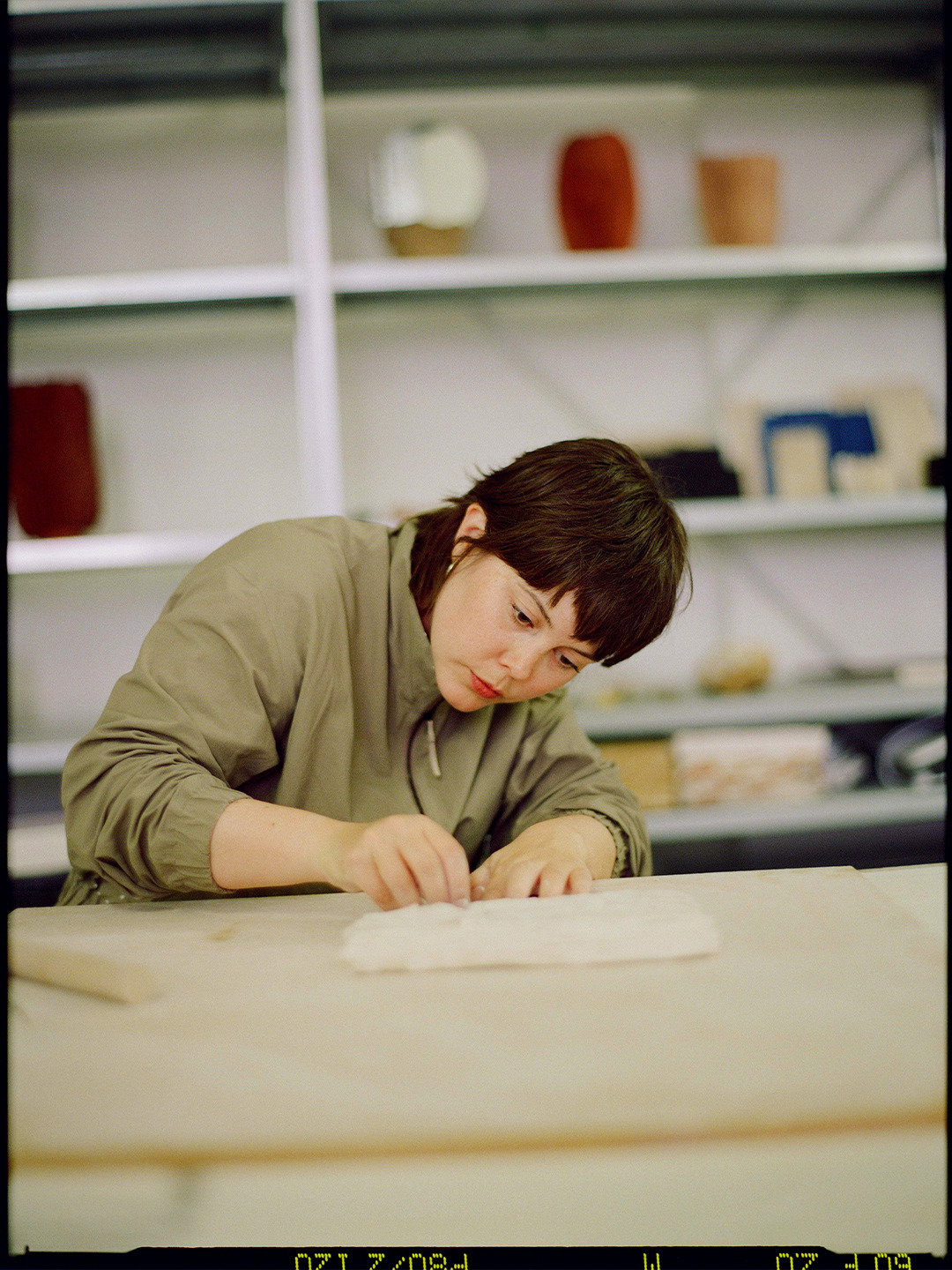 Arc'teryx Translating Flow State: Ceramic artist working by hand at a studio table.