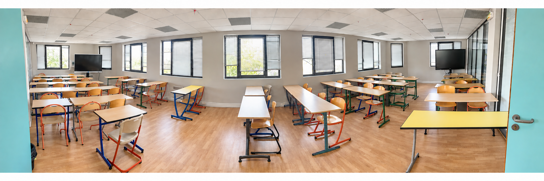 Vue panoramique de l’amphithéâtre de l’ESCC, avec les tables et les écrans de présentation