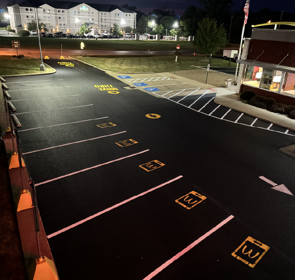 Newly painted pavement markings on a commercial parking lot at night