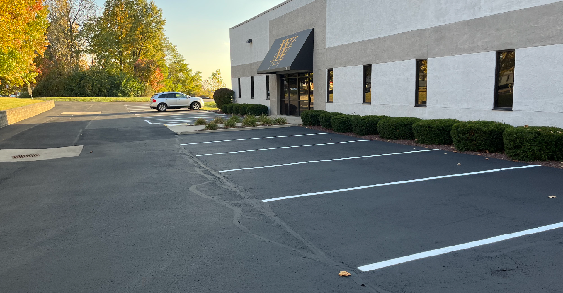 Commercial parking lot beside an office building, maintained by A&D Asphalt