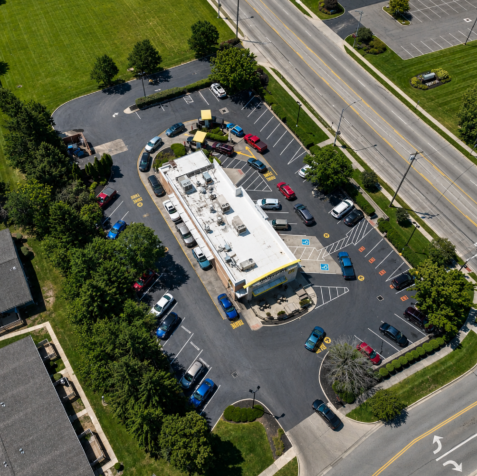 Aerial view of a commercial property and parking lot maintained by A&D Asphalt