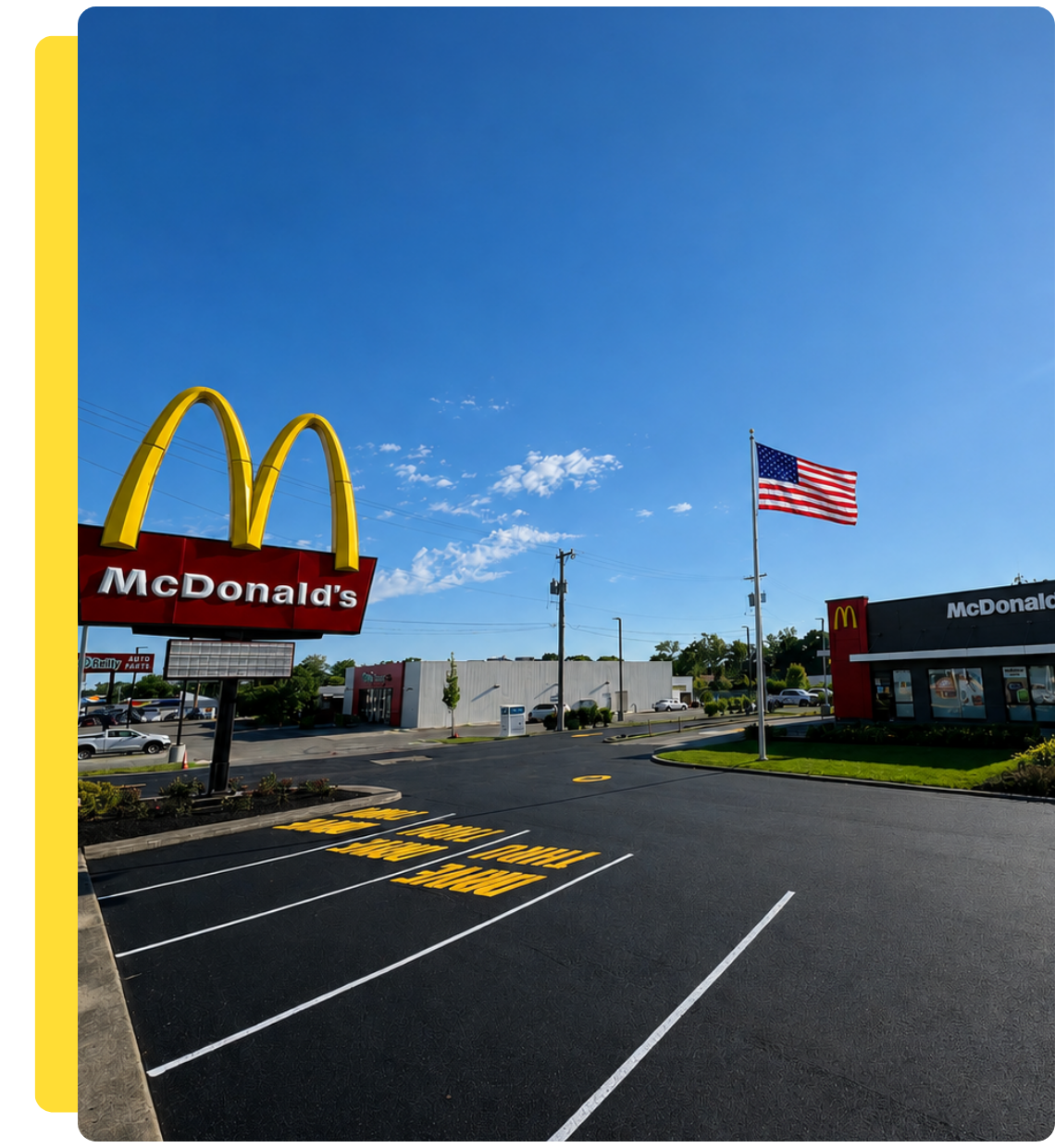 Newly sealcoated and restriped McDonald's parking lot with fresh yellow parking lines by A&D Asphalt