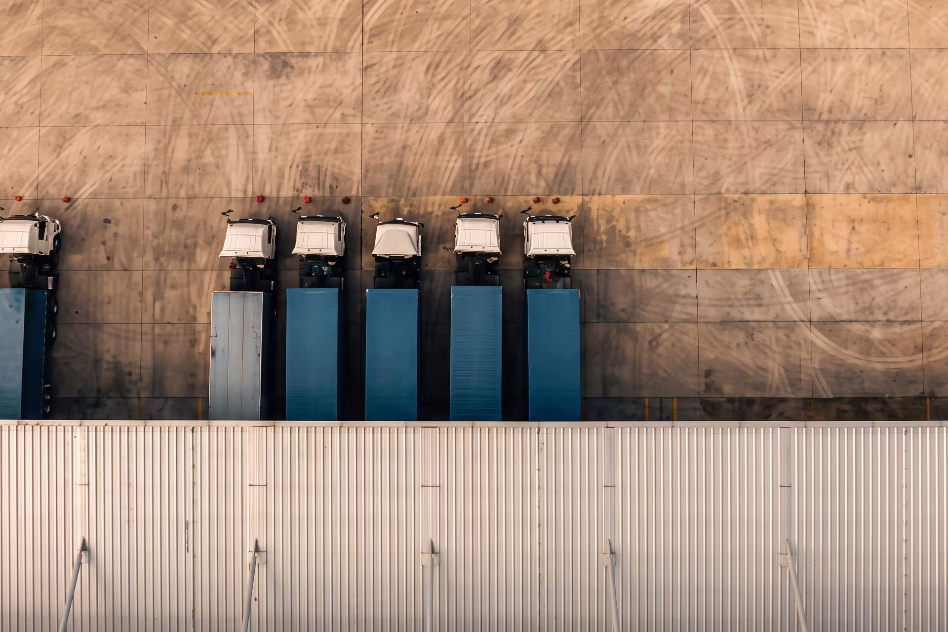 Aerial view of trucks backed into loading dock doors at a distribution center