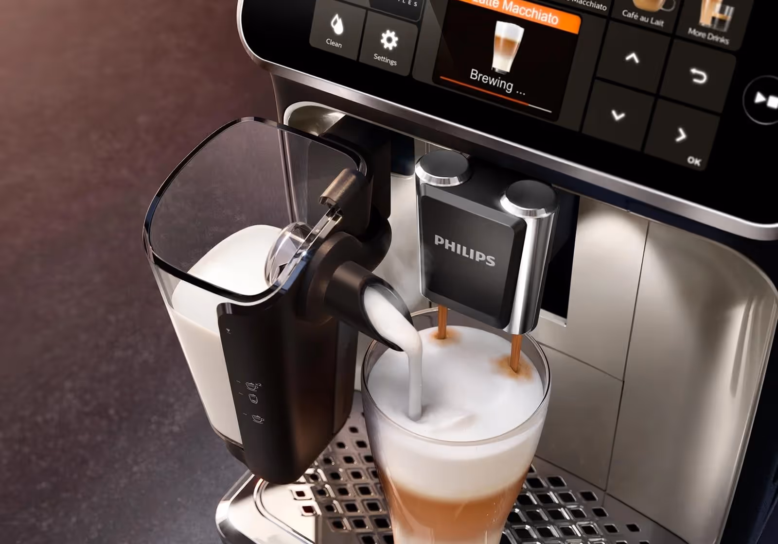 Philips coffee machine froths milk and brews a latte macchiato in a clear glass.