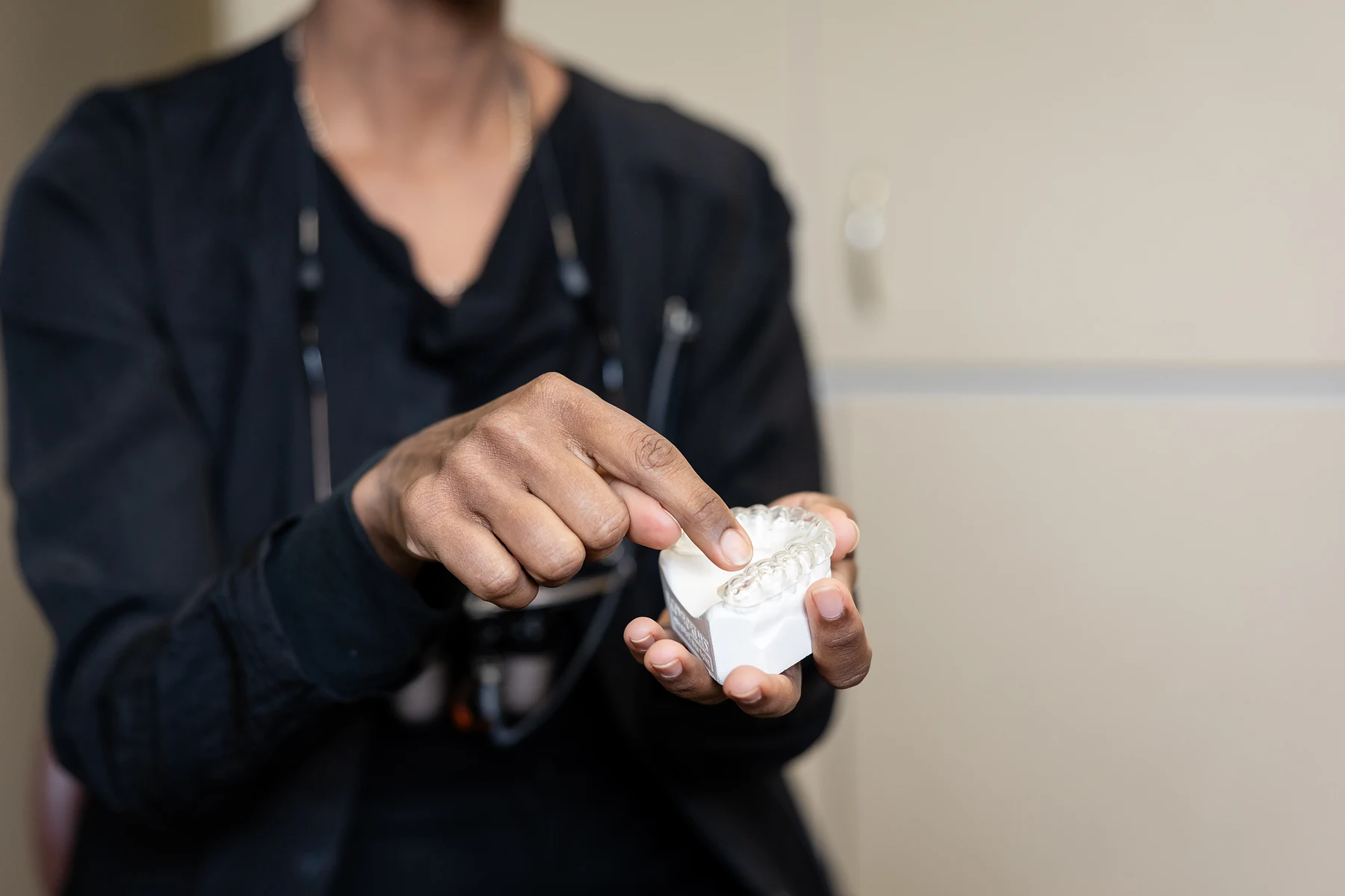 A dental team member holding the stone model a custom guard is made from