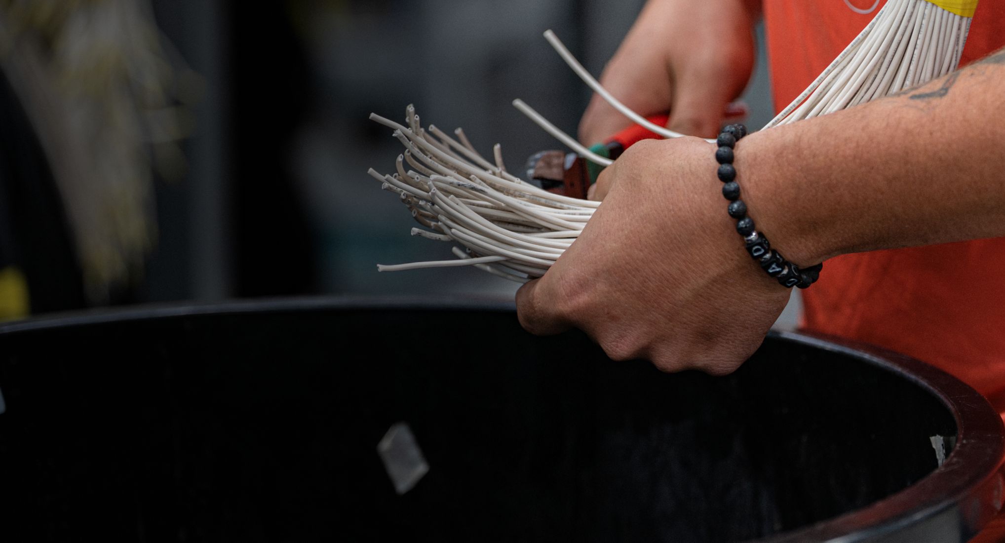 Technician preparing branch circuit whip wiring at an Accelevation workstation