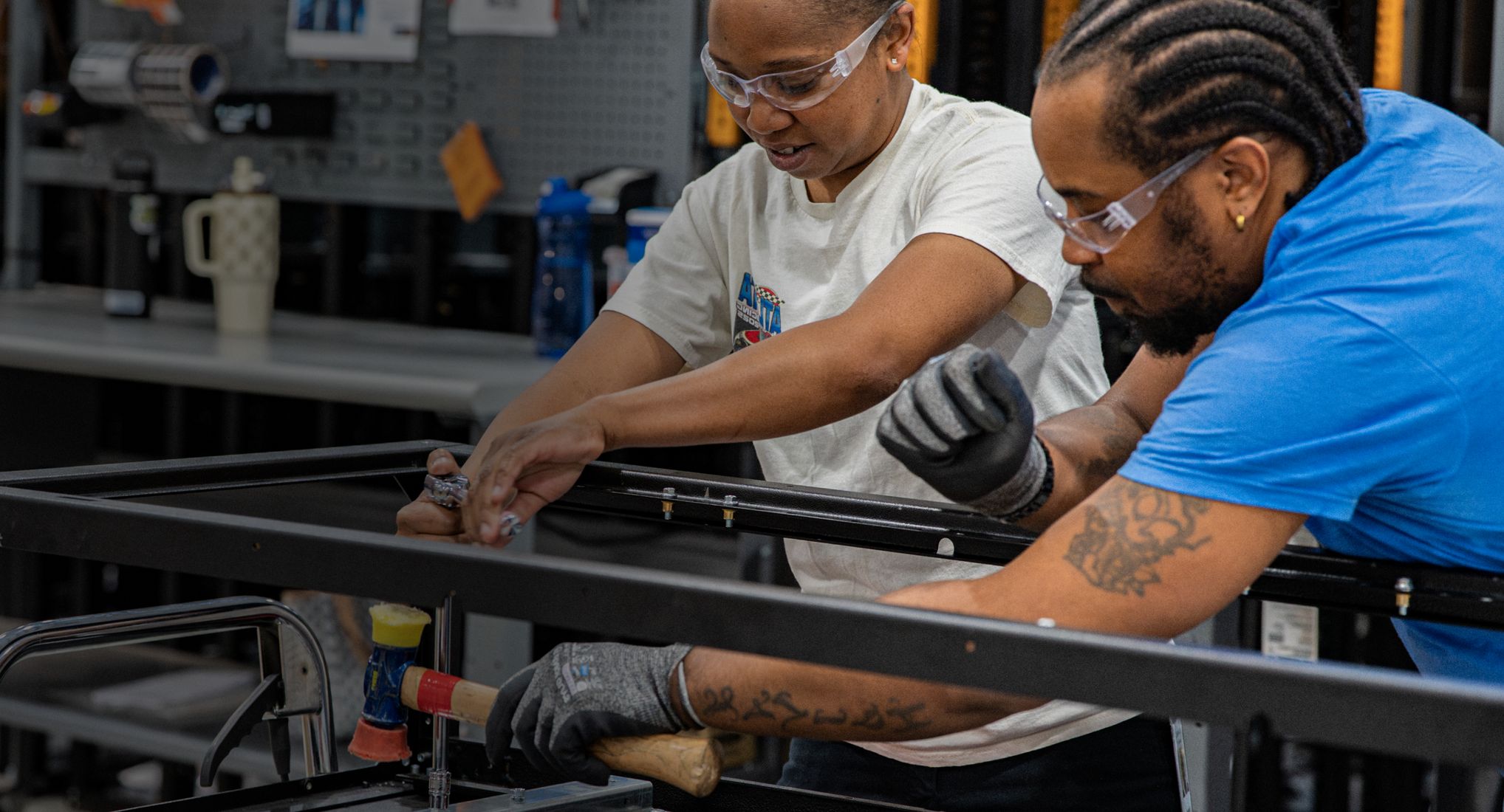 Two Accelevation technicians assembling infrastructure framing together