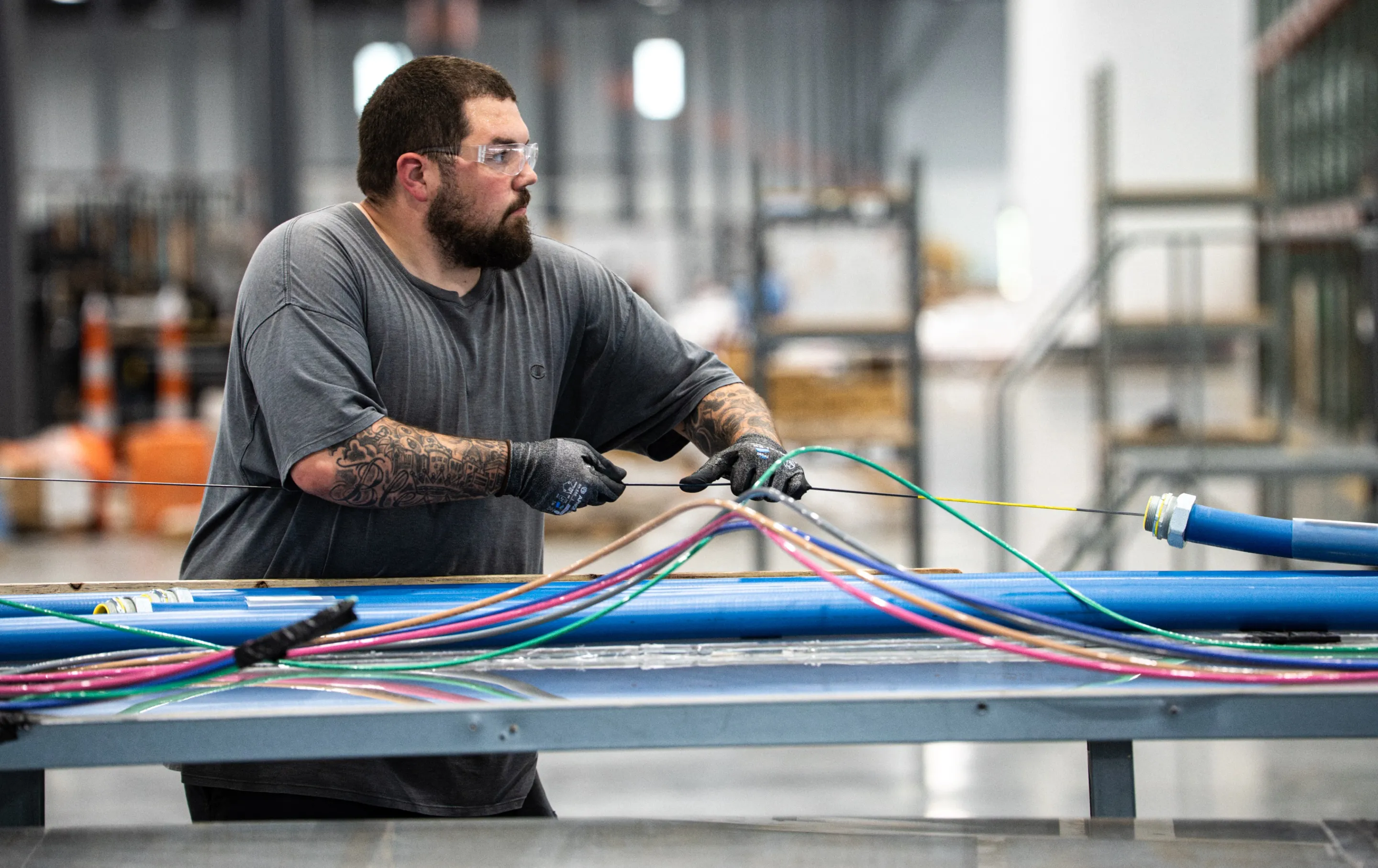 Accelevation technician assembling branch circuit whips on a workbench