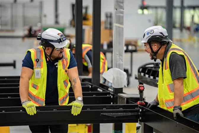 Accelevation team members collaborating on the production floor
