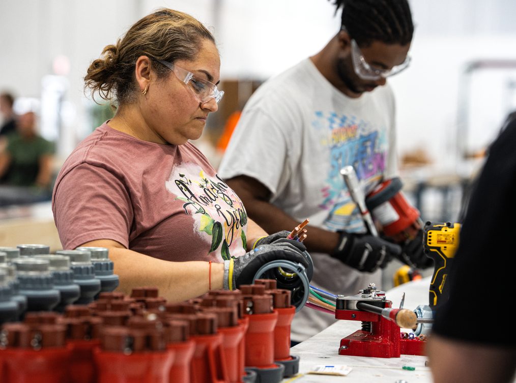 Technicians assembling power distribution components