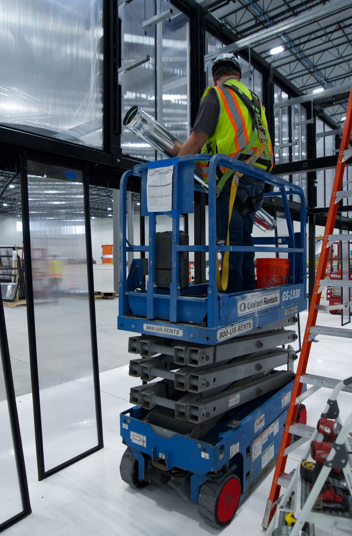 Worker installing overhead cable conveyance
