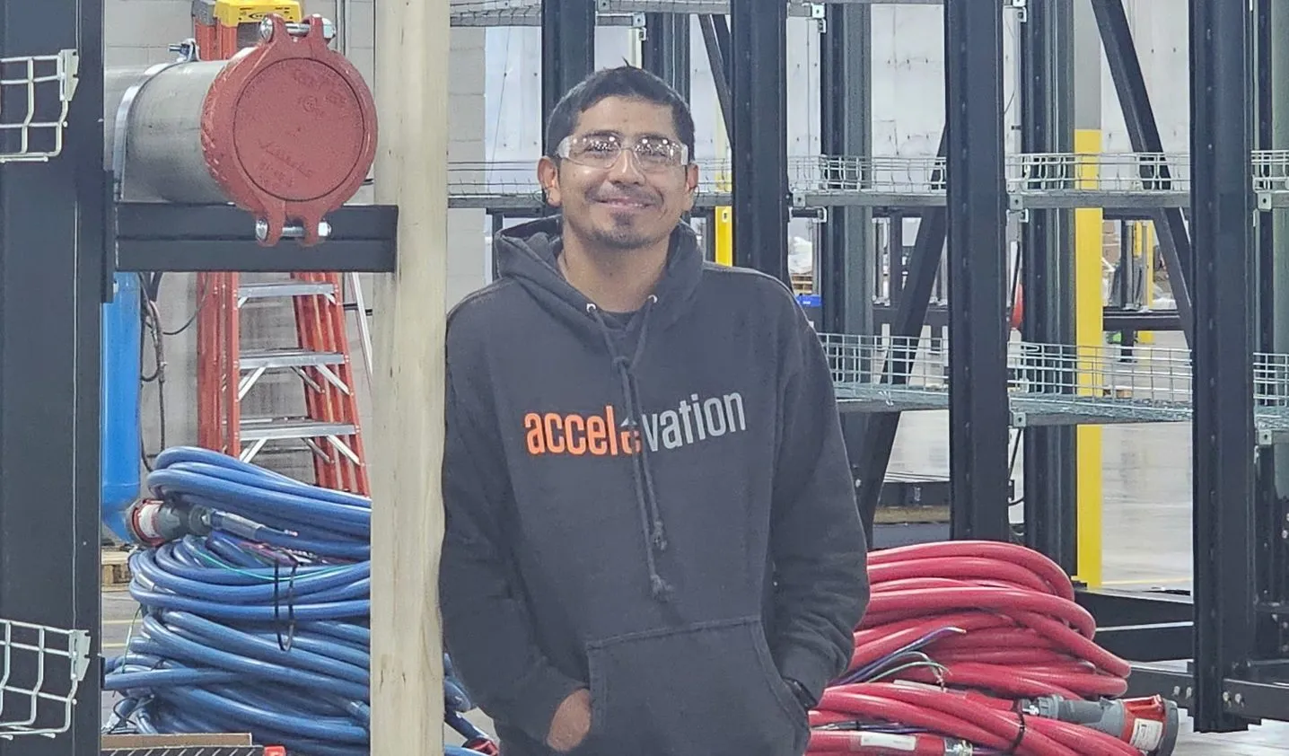 Fernando Castro beside conduit racks