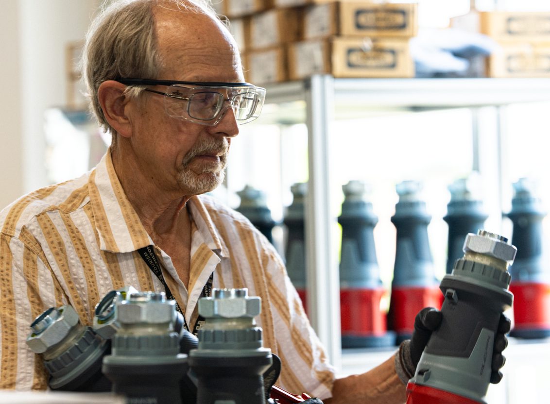 Technician handling grey and red structured cabling connectors