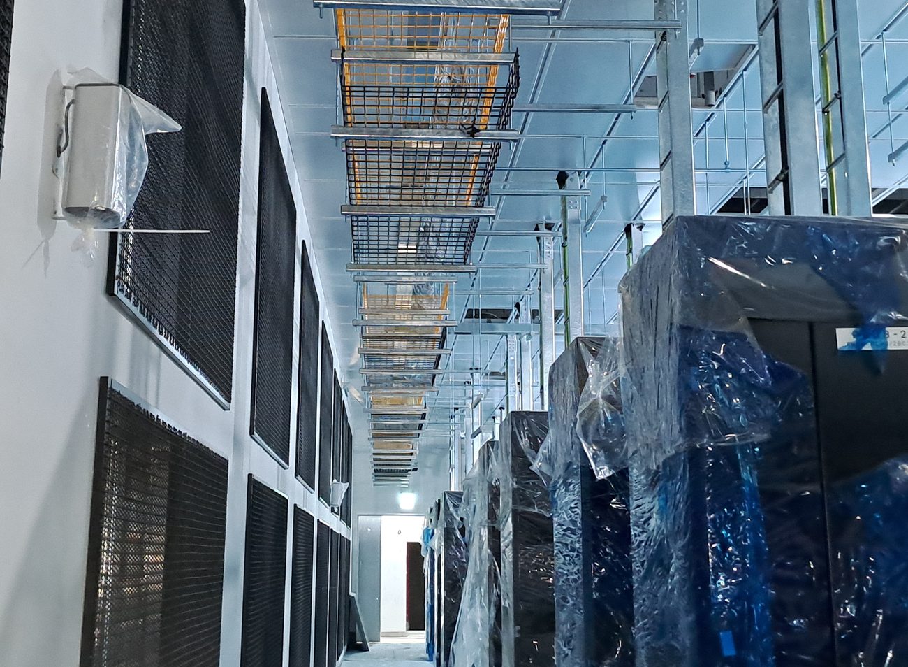 Technician removing equipment during a data centre decommission