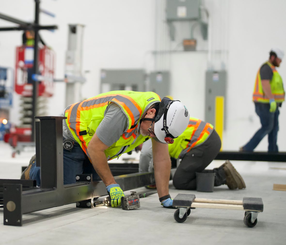 Technician assembling steel supports on the shop floor