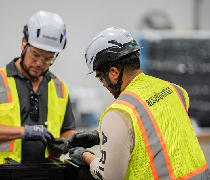 Two Accelevation technicians reviewing equipment on site