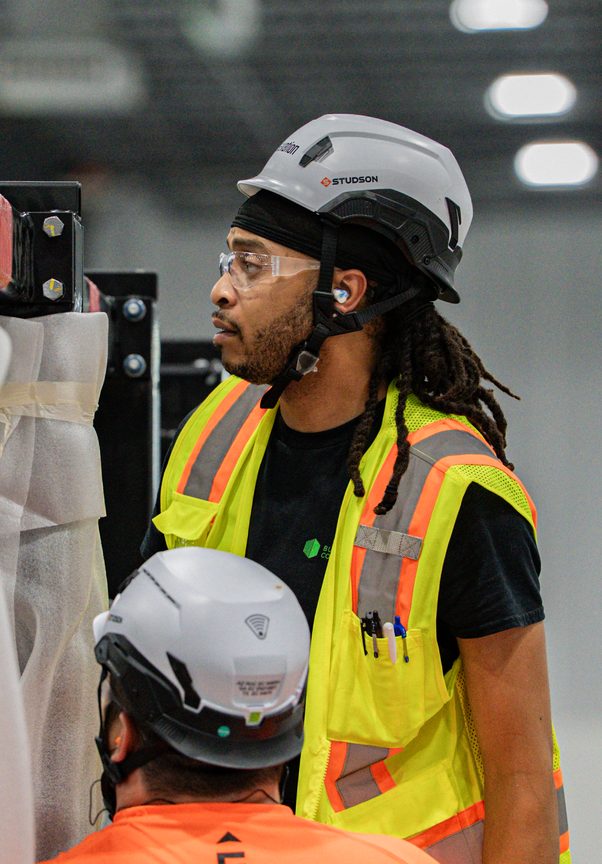 Technicians reviewing equipment on the production floor