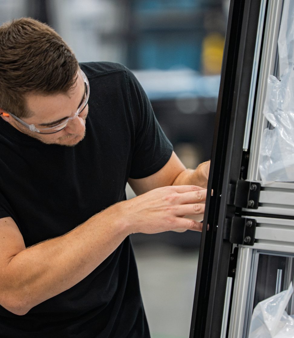 Technician assembling a cabinet frame