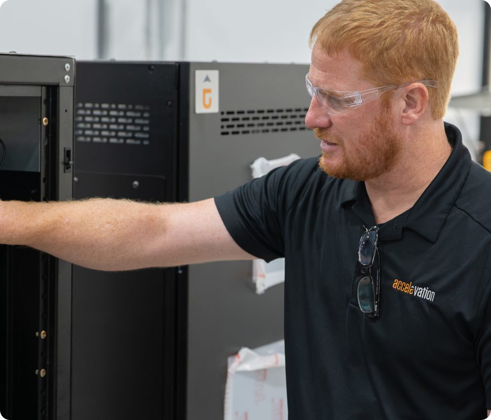 Accelevation engineer commissioning a power distribution cabinet