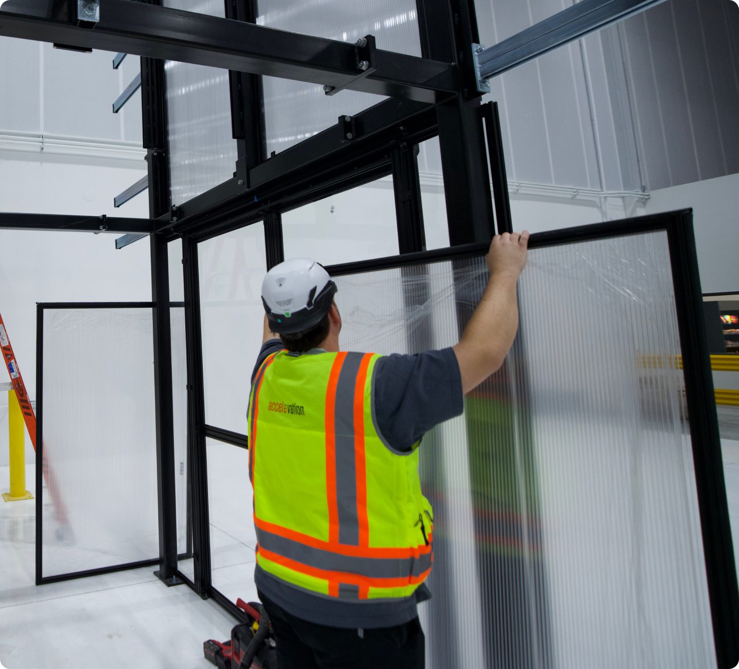 Technician installing a data center containment frame