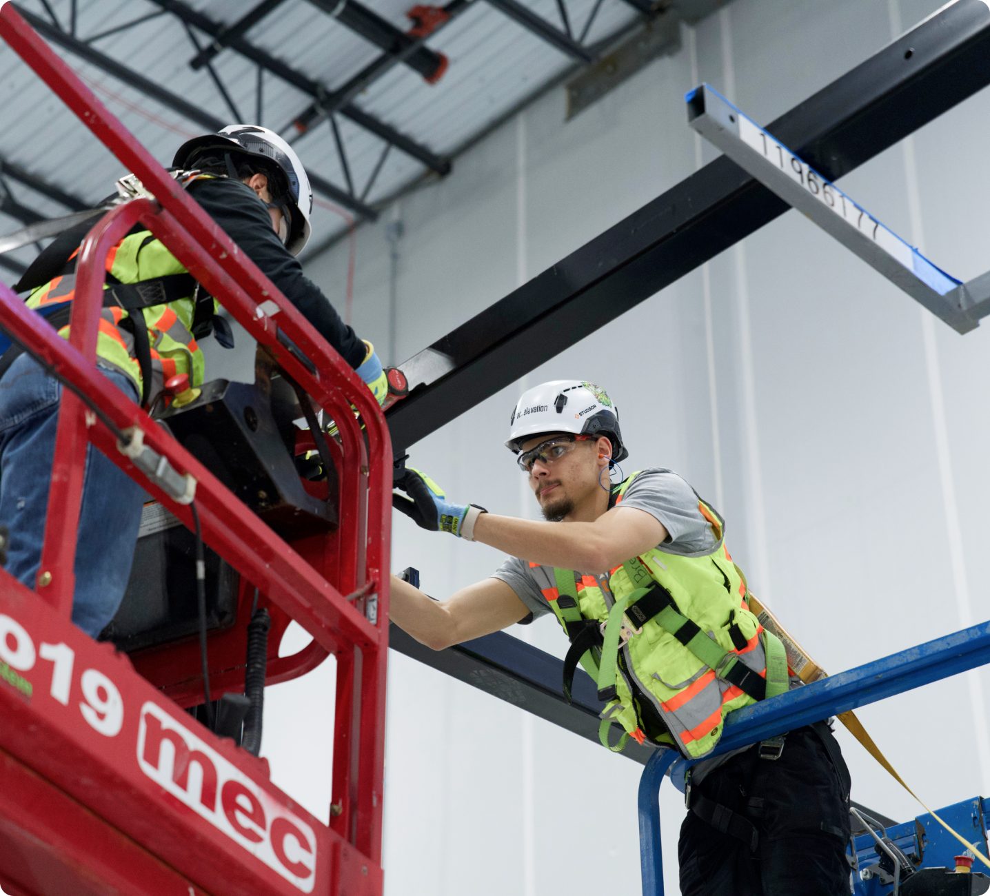 Worker on a lift installing overhead infrastructure