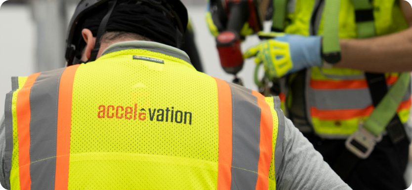 Accelevation crew in branded hi-vis on the production floor.