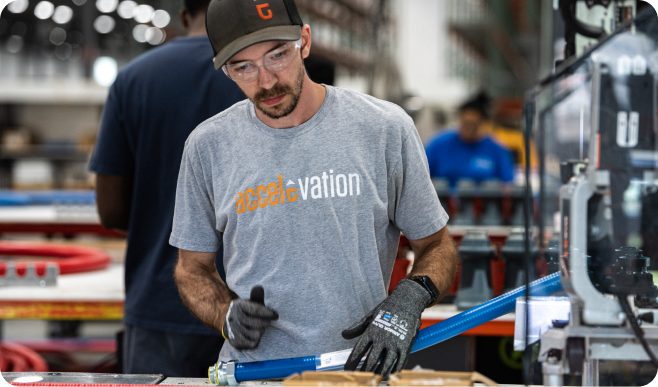 Technician assembling a power component at a workbench.