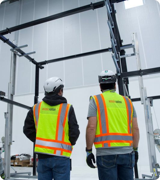 Field technicians in high-visibility gear at a data center loading bay