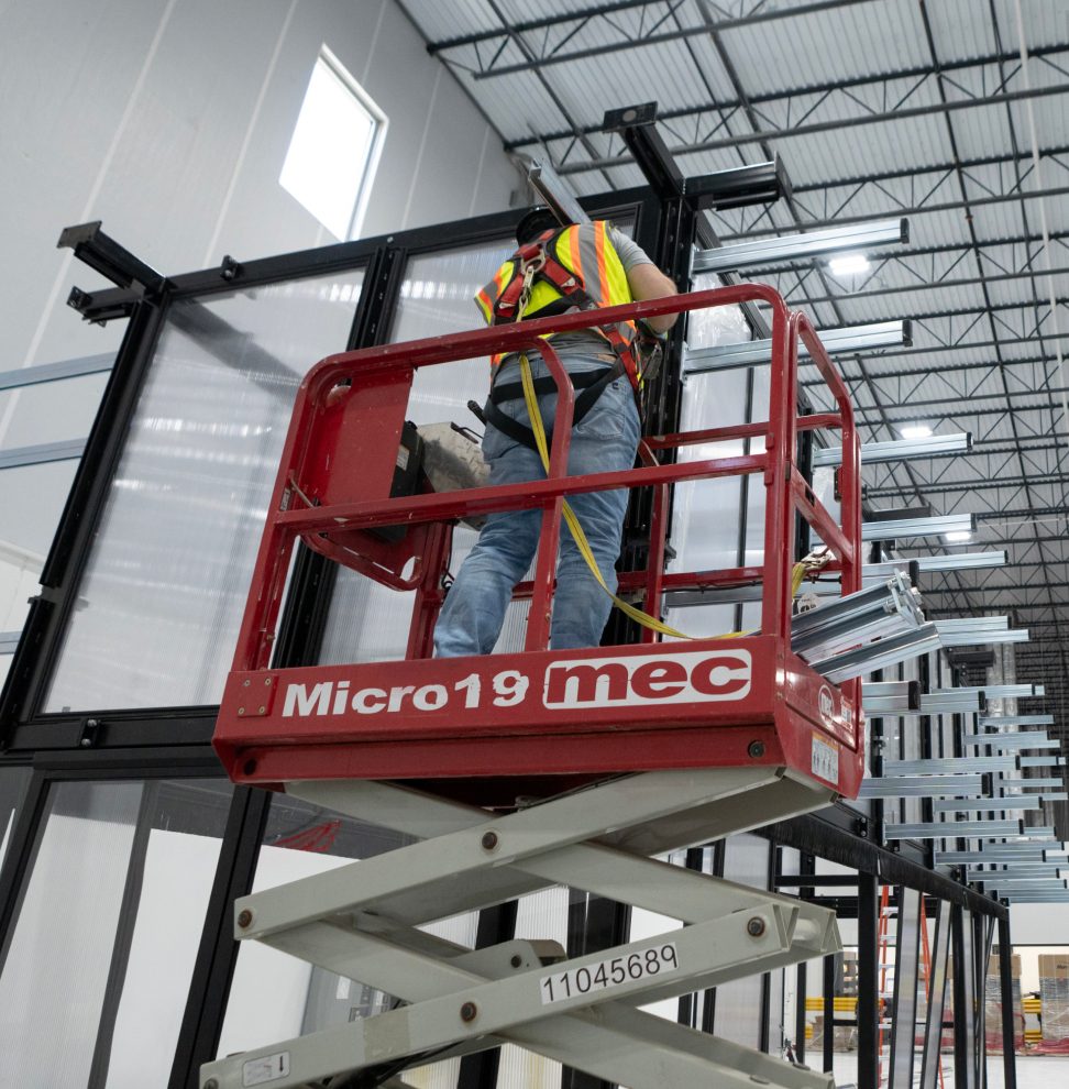 Hot aisle containment panels being installed from a lift inside a data hall