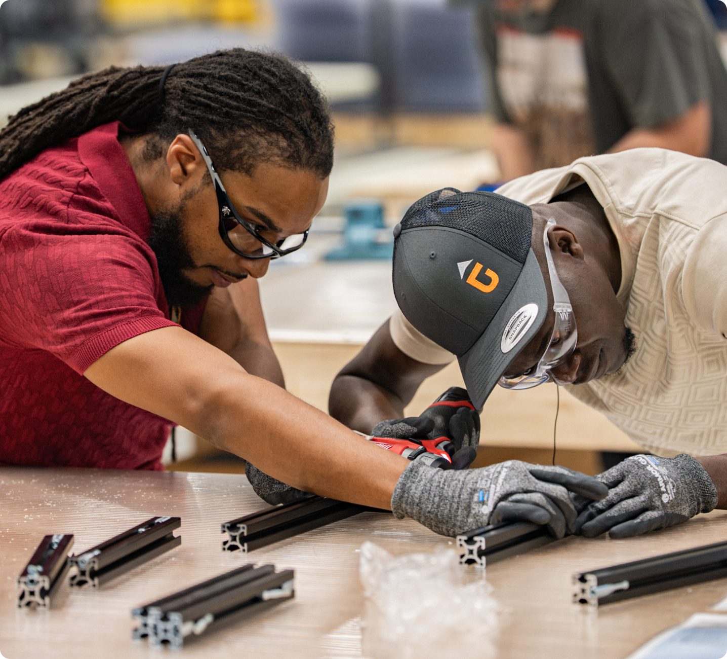Two Accelevation workers at the extrusion bench
