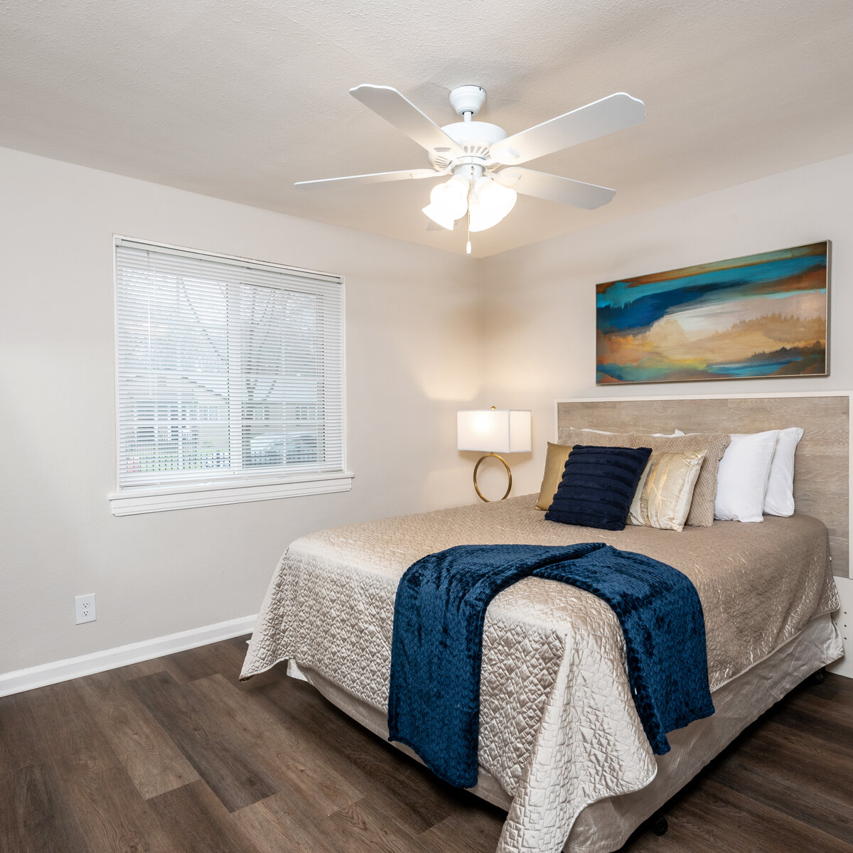 Bedroom with large bed and well lit indow