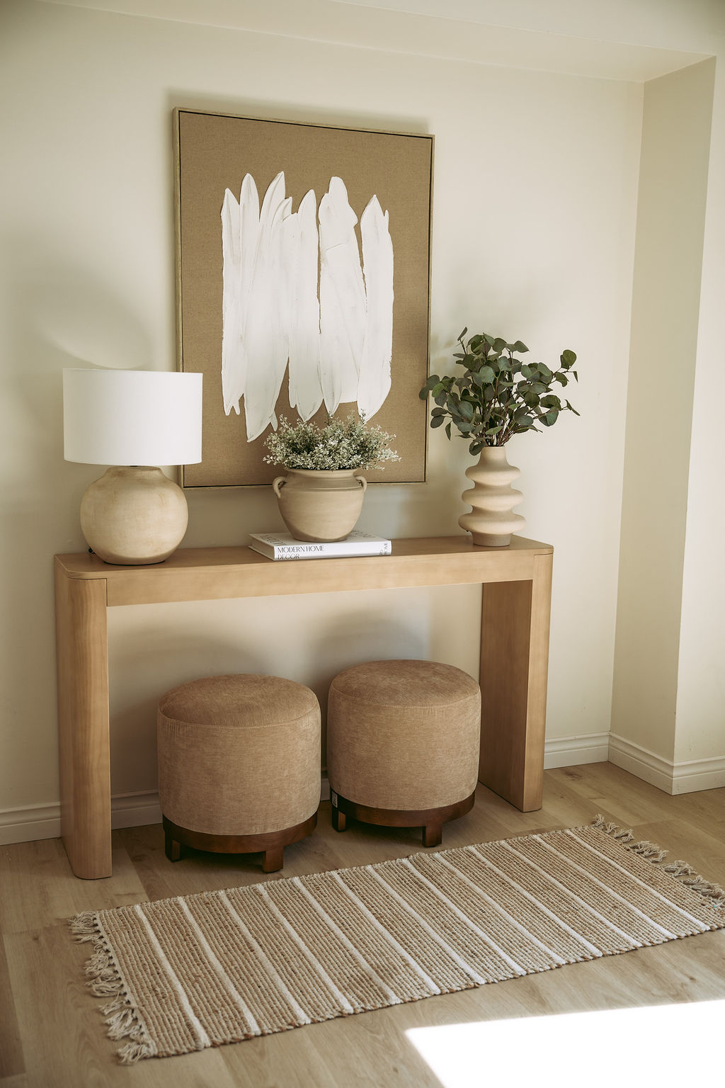 Sunlit living room with neutral tones and large glass doors