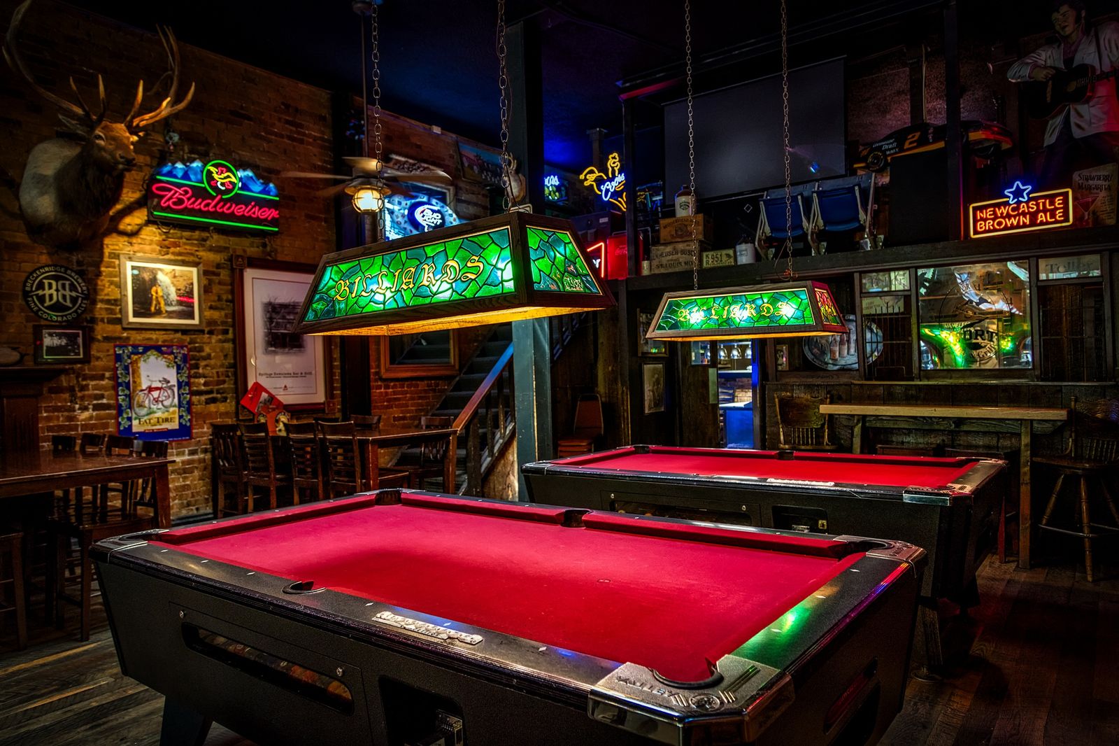 Pool tables and the bar in The Lounge at Encore Waco