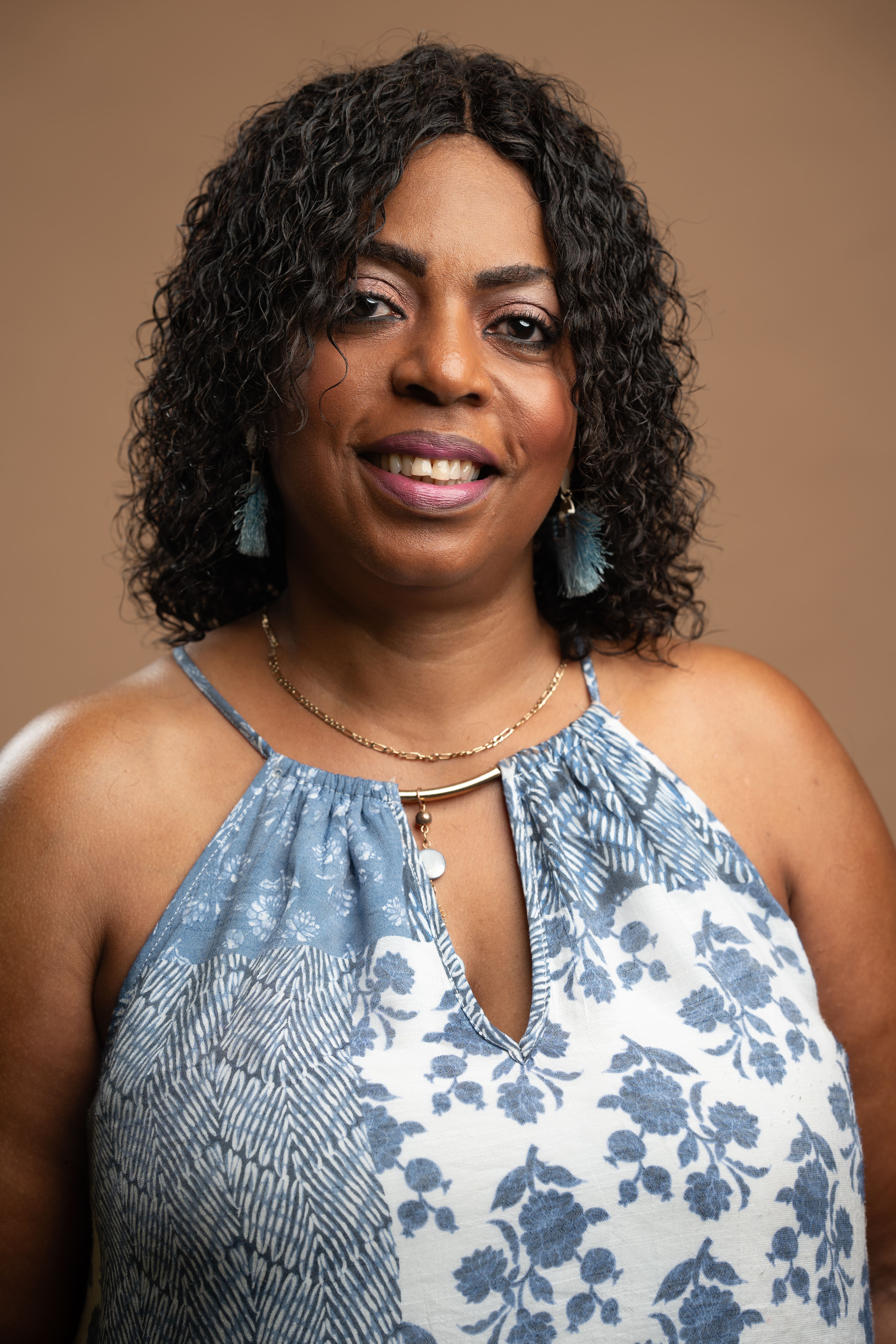 Staff portrait of J. Akitcher smiling in professional headshot