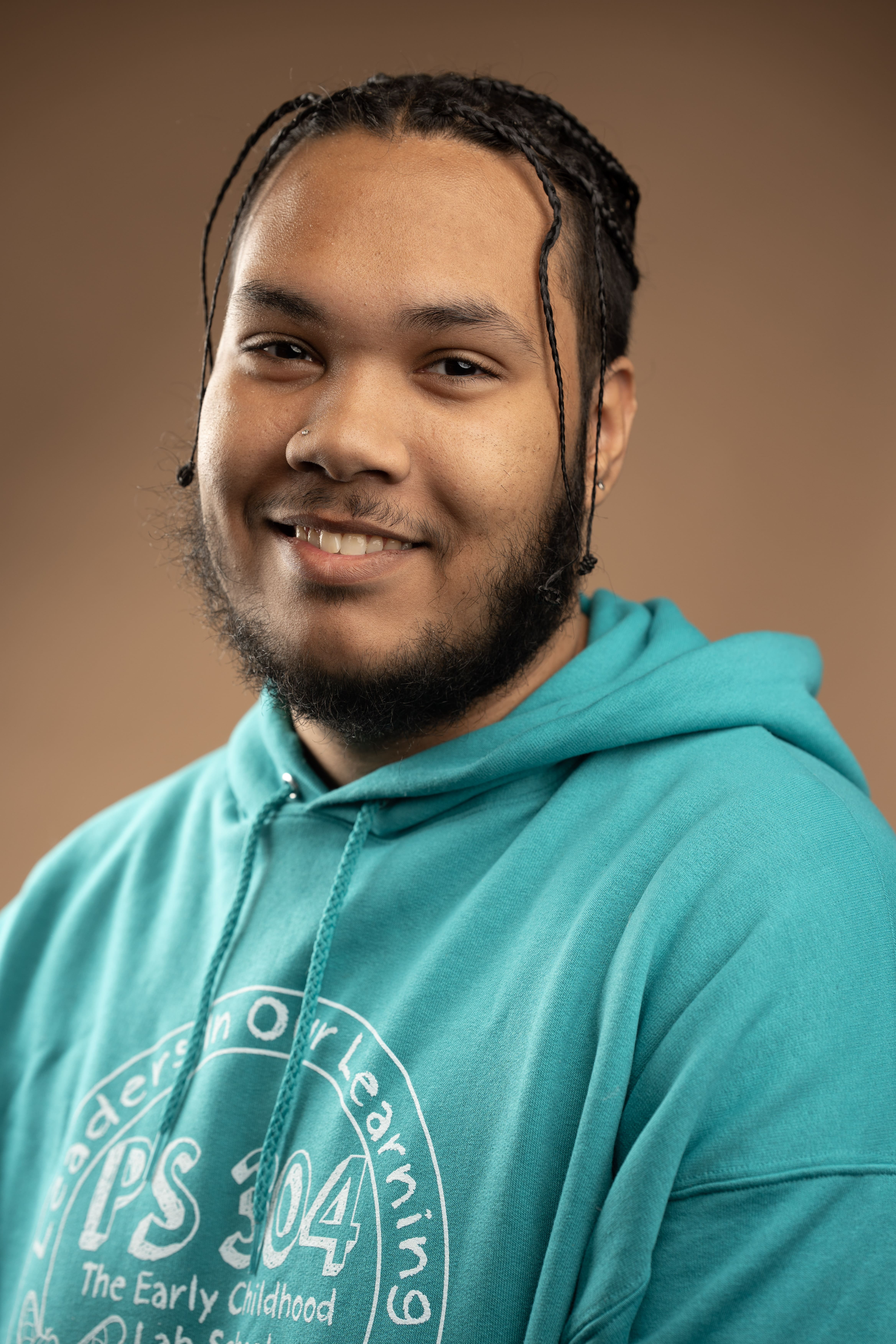 Staff member K. Solinal smiling in PS 304 school hoodie